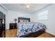 Bedroom with a large bed, hardwood floors, and a nightstand at 3444 Clydesdale Dr, Holiday, FL 34691