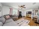 Living area includes a cozy sectional couch, an entertainment center, and attractive flooring at 3444 Clydesdale Dr, Holiday, FL 34691