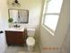 Updated bathroom features a modern vanity, toilet, and stylish mirror at 3606 River Grove Dr, Tampa, FL 33610
