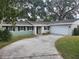 Charming light green house with a two-car garage at 3606 River Grove Dr, Tampa, FL 33610
