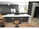 Modern kitchen with dark cabinetry and island at 3606 River Grove Dr, Tampa, FL 33610