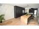 Modern kitchen boasts dark cabinetry, marble backsplash, and a large island with seating at 3606 River Grove Dr, Tampa, FL 33610