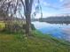 Waterfront lot with a large oak tree and lake view at 3606 River Grove Dr, Tampa, FL 33610