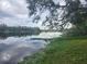 Tranquil waterfront view with a calm lake and cloudy sky at 3606 River Grove Dr, Tampa, FL 33610