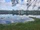 Calm lake view with houses in the background at 3606 River Grove Dr, Tampa, FL 33610