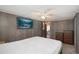 Bedroom featuring a ceiling fan, wooden dresser, and fish wall art at 3844 Kim Dr, Wesley Chapel, FL 33543