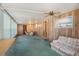 Comfortable den/Gathering room with carpeted floors, large windows, and ceiling fan at 3844 Kim Dr, Wesley Chapel, FL 33543