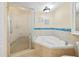 Bathroom with a corner jetted tub, a glass shower, and tiled walls at 4516 Seagull Dr # 805, New Port Richey, FL 34652