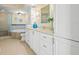 Bright bathroom featuring white cabinets, a jetted tub, and tiled floors at 4516 Seagull Dr # 805, New Port Richey, FL 34652