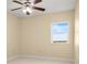 Spacious bedroom with neutral walls, plush carpeting, and large window with scenic views at 4516 Seagull Dr # 805, New Port Richey, FL 34652