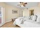 Relaxing bedroom with white bedding, balcony access, and wooden floors at 4516 Seagull Dr # 805, New Port Richey, FL 34652