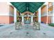 Welcoming entrance with a covered area, benches, and a unique giraffe statue at 4516 Seagull Dr # 805, New Port Richey, FL 34652