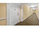 Well-lit hallway leading to individual condo units at 4516 Seagull Dr # 805, New Port Richey, FL 34652