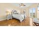 Tastefully decorated main bedroom with hardwood floors and natural light from large sliding doors at 4516 Seagull Dr # 805, New Port Richey, FL 34652