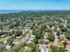 Aerial view of a residential area with lots of green trees and houses with solar panels at 4629 26Th S Ave, St Petersburg, FL 33711