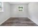 Spacious bedroom with gray wood-look floors and plenty of natural light at 4629 26Th S Ave, St Petersburg, FL 33711