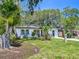 White home with new windows, landscaping, and mature trees at 4629 26Th S Ave, St Petersburg, FL 33711