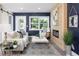 Cozy living room with wood accent wall, fireplace, and large windows at 4629 26Th S Ave, St Petersburg, FL 33711