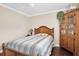 Cozy bedroom with a blue striped bedspread and wooden accents, featuring a vintage wooden cabinet at 4846 Leyte Ct, New Port Richey, FL 34655