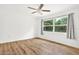 Bright bedroom with wood-look floors and large windows at 6288 Airmont Dr, Spring Hill, FL 34606