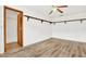 Well-lit bedroom with wood-look floors and ample closet space at 6288 Airmont Dr, Spring Hill, FL 34606