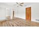 Bedroom with mirrored closet doors and wood-look floors at 6288 Airmont Dr, Spring Hill, FL 34606