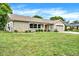Ranch style home with a spacious lawn and mature trees at 6288 Airmont Dr, Spring Hill, FL 34606