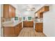 Kitchen with wood cabinets, vinyl flooring and white appliances at 6288 Airmont Dr, Spring Hill, FL 34606