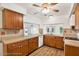 Galley style kitchen with wood cabinets and access to the backyard at 6288 Airmont Dr, Spring Hill, FL 34606
