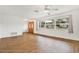 Living room with hardwood floors, large window, and double doors at 6288 Airmont Dr, Spring Hill, FL 34606