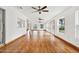 Sunlit living room with hardwood floors and ceiling fans at 6288 Airmont Dr, Spring Hill, FL 34606