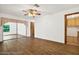 Spacious living area with wood-look floors and access to other rooms at 6288 Airmont Dr, Spring Hill, FL 34606