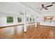 Large living room with hardwood floors and kitchen view at 6288 Airmont Dr, Spring Hill, FL 34606