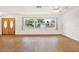 Living room with hardwood floors, large window, and double doors at 6288 Airmont Dr, Spring Hill, FL 34606