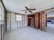 Large bedroom with new tile flooring, a wood-paneled closet, and exposed framing at 6404 Kathleen Dr, Hudson, FL 34667