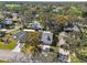 An aerial view of a residential neighborhood with houses surrounded by trees at 6409 Wedgewood Dr, Spring Hill, FL 34606