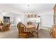 Dining room with chandelier, round table, and view of the kitchen at 6409 Wedgewood Dr, Spring Hill, FL 34606