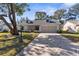 Attractive home with a patterned driveway, landscaping, and covered entryway at 6409 Wedgewood Dr, Spring Hill, FL 34606