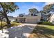 Inviting home with a decorative driveway, landscaping, and attached garage at 6409 Wedgewood Dr, Spring Hill, FL 34606