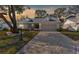 Charming single-story home with a patterned driveway and landscaping at sunset at 6409 Wedgewood Dr, Spring Hill, FL 34606