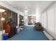 Florida room with blue carpets, wicker furniture, and ample natural light at 6409 Wedgewood Dr, Spring Hill, FL 34606