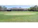 Golf course with clubhouse, putting green, trees, and landscaping at 6409 Wedgewood Dr, Spring Hill, FL 34606