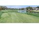 View of a golf course with water feature and residential properties at 6409 Wedgewood Dr, Spring Hill, FL 34606