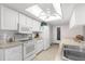 Bright kitchen with white appliances, ample counter space, and a skylight at 6409 Wedgewood Dr, Spring Hill, FL 34606