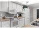 White kitchen featuring essential appliances, ample counter space, and a convenient layout at 6409 Wedgewood Dr, Spring Hill, FL 34606