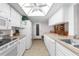 Well-equipped kitchen with white cabinetry, ample counter space, and access to a dining area at 6409 Wedgewood Dr, Spring Hill, FL 34606
