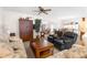 Living room featuring a sofa, recliner chairs, and a view into the adjacent dining area at 6409 Wedgewood Dr, Spring Hill, FL 34606