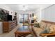 Inviting living room with wicker furniture, a TV, and access to a bedroom at 6409 Wedgewood Dr, Spring Hill, FL 34606