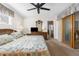 Main bedroom featuring carpeted floors, a ceiling fan, and an ensuite bathroom at 6409 Wedgewood Dr, Spring Hill, FL 34606