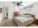 Large main bedroom with carpeted floors, ceiling fan, and ensuite bathroom access at 6409 Wedgewood Dr, Spring Hill, FL 34606